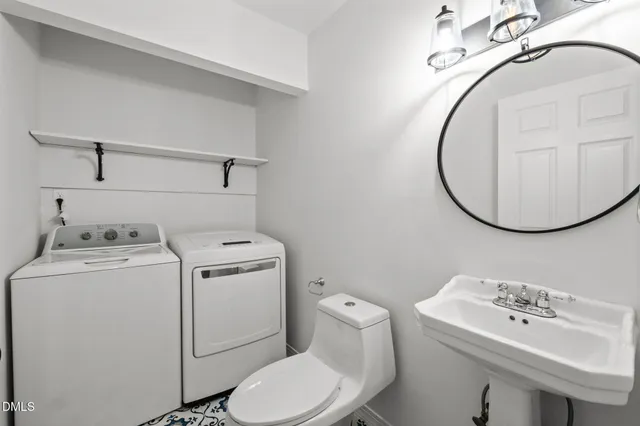 a bathroom with a sink a toilet and a mirror