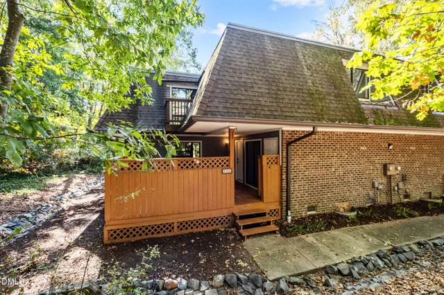 a view of a house with a yard and sitting area