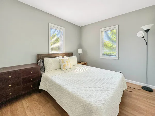 a large bed sitting in a bedroom next to a window