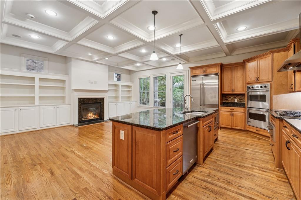 1220 State Street Northwest Atlanta, GA 30318 - Photo 11 of 40 a kitchen with stainless steel appliances granite countertop a stove and a wooden floors