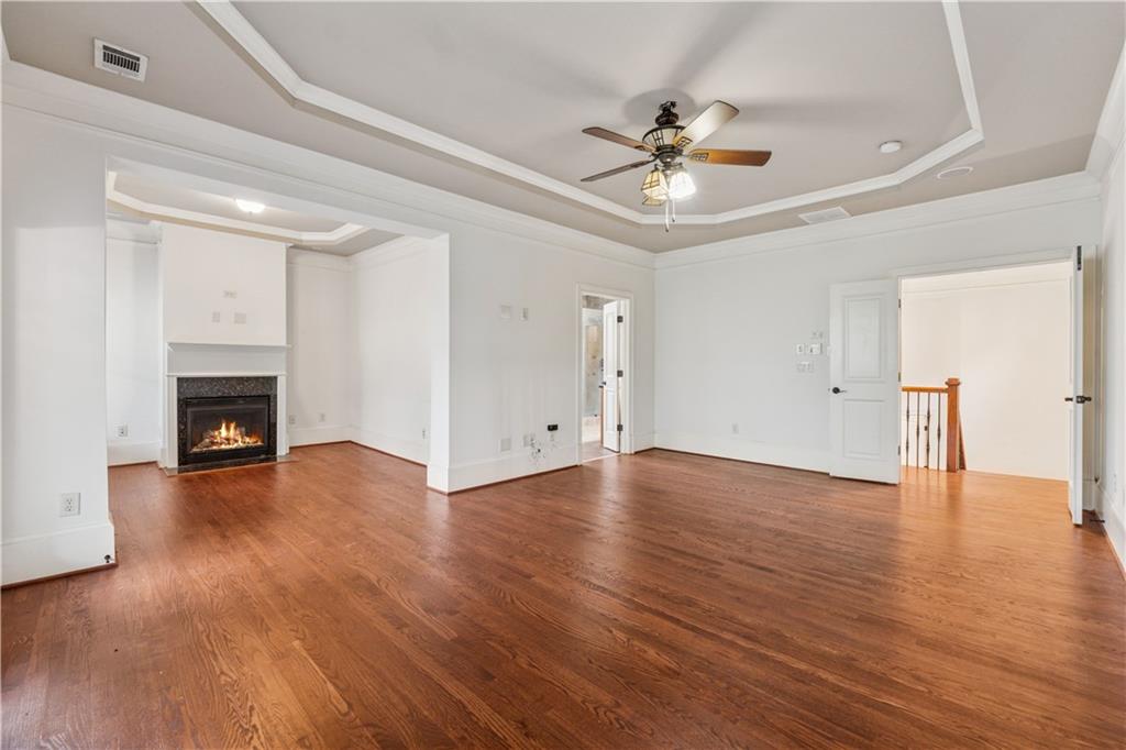 1220 State Street Northwest Atlanta, GA 30318 - Photo 15 of 40 a view of an empty room with wooden floor and a ceiling fan