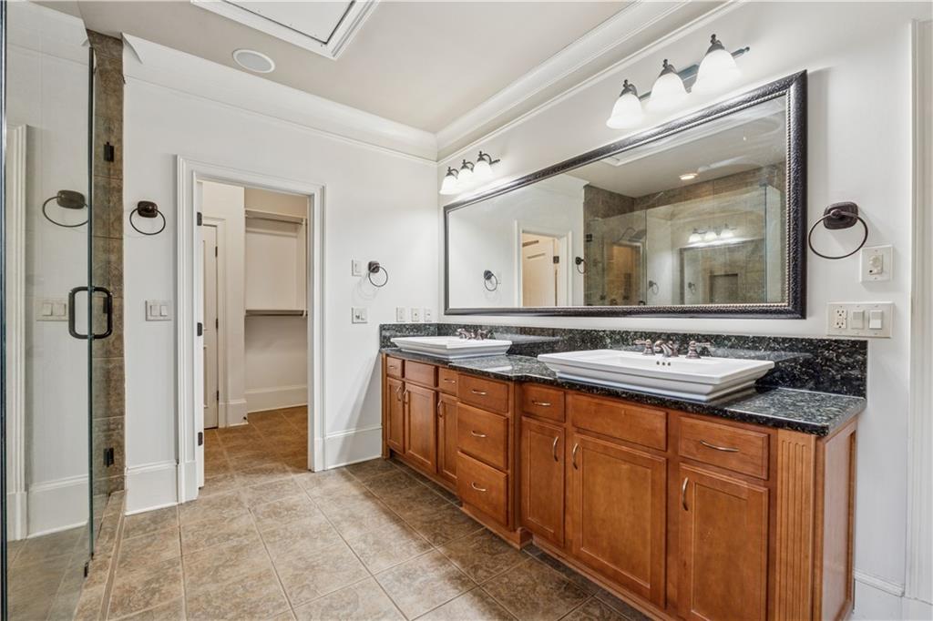 1220 State Street Northwest Atlanta, GA 30318 - Photo 19 of 40 a bathroom with a granite countertop sink and a mirror