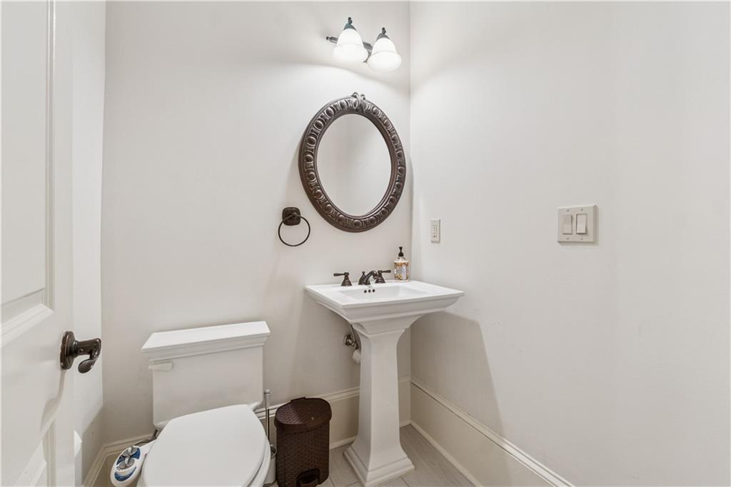 1220 State Street Northwest Atlanta, GA 30318 - Photo 22 of 40 a bathroom with a sink a toilet and a mirror