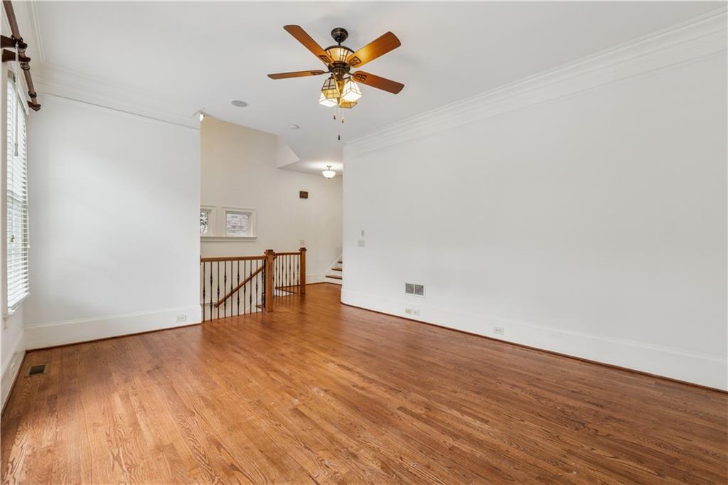 1220 State Street Northwest Atlanta, GA 30318 - Photo 5 of 40 a view of an empty room with a window and wooden floor