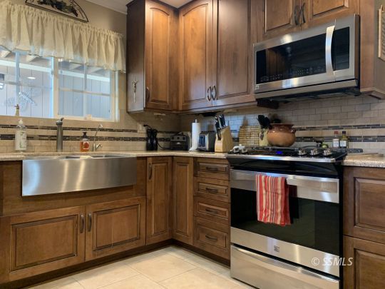 1320 Mayo Street Ridgecrest, CA 93555 - Photo 15 of 45 a kitchen with stainless steel appliances granite countertop a stove and a microwave
