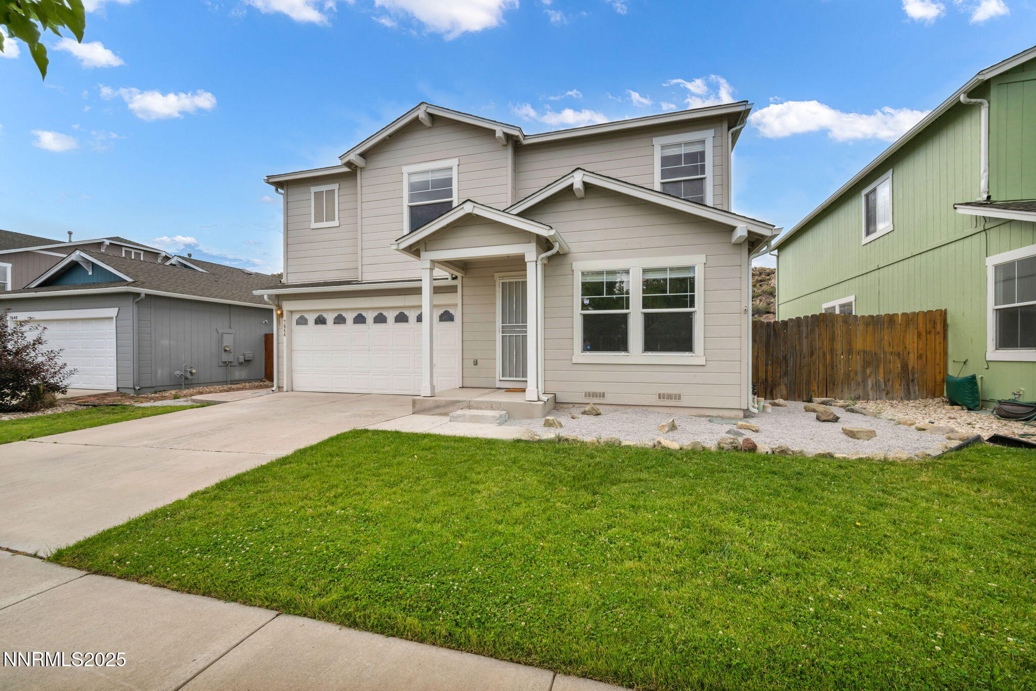 7644 Corso Street Reno, NV 89506 - Photo 1 of 54 a front view of a house with a yard and porch