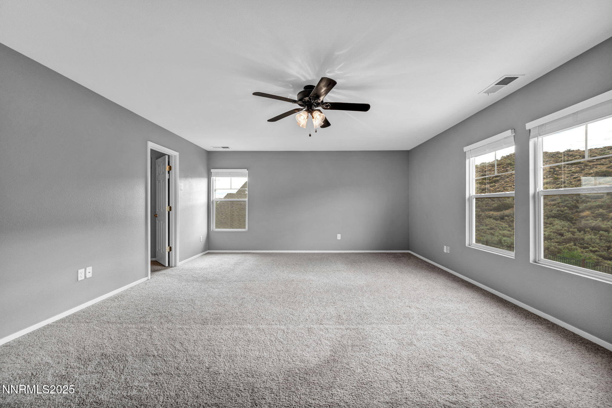 7644 Corso Street Reno, NV 89506 - Photo 19 of 54 a view of a room with a ceiling fan and window