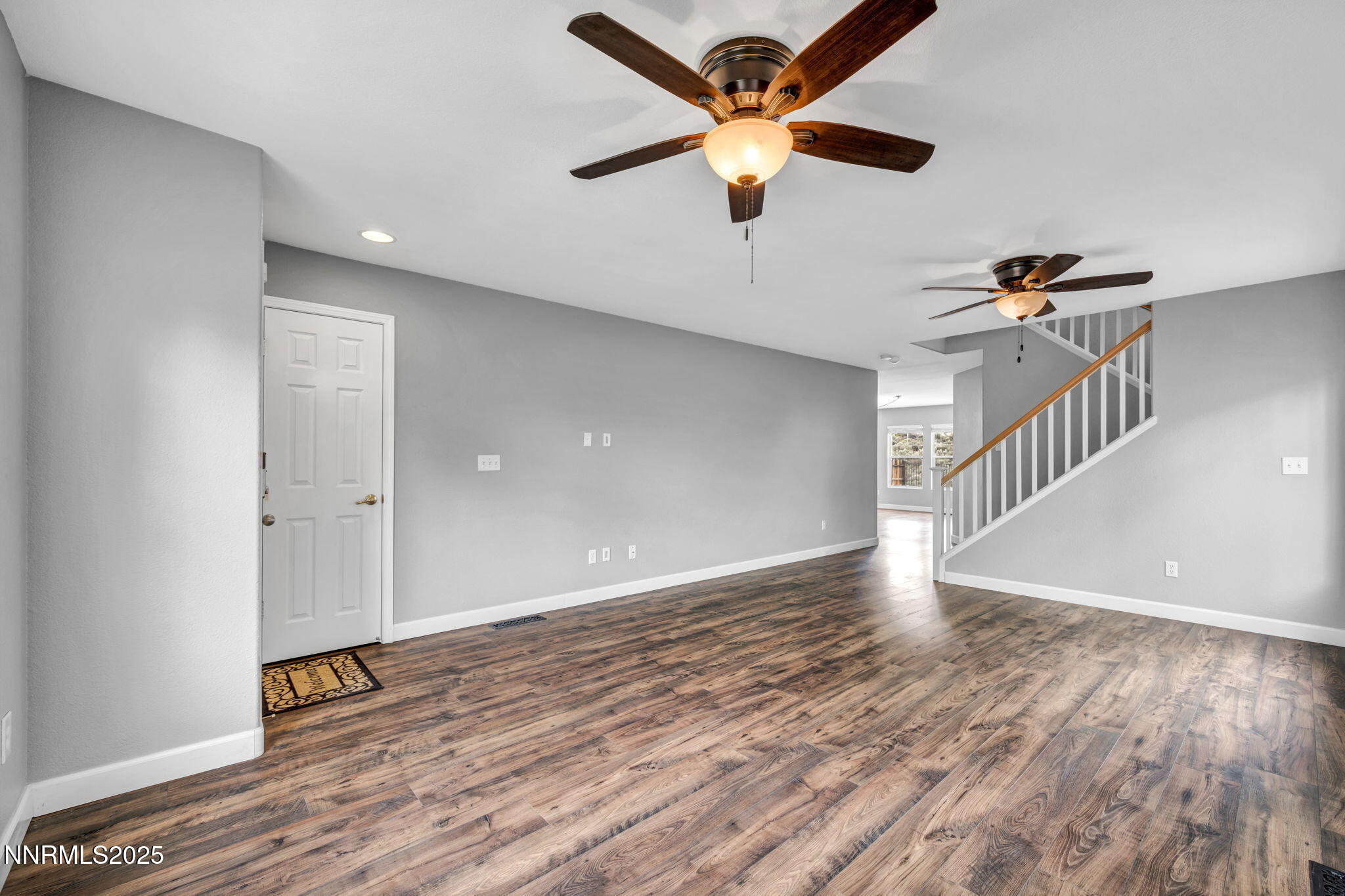 7644 Corso Street Reno, NV 89506 - Photo 2 of 54 a view of an empty room with a window and wooden floor