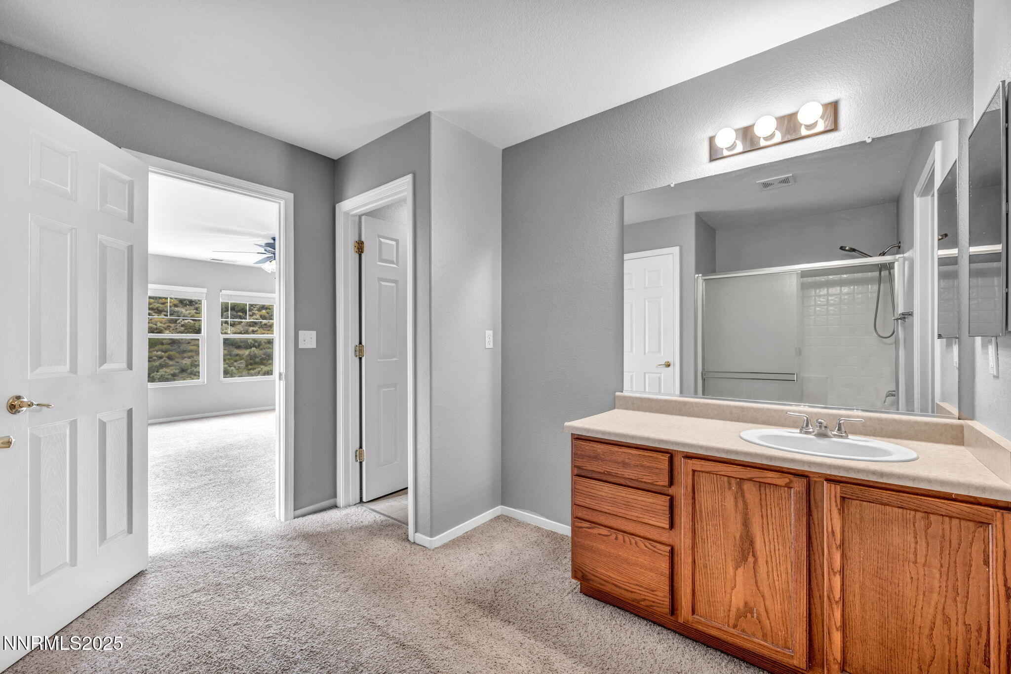 7644 Corso Street Reno, NV 89506 - Photo 32 of 54 a spacious bathroom with a double vanity sink and a mirror