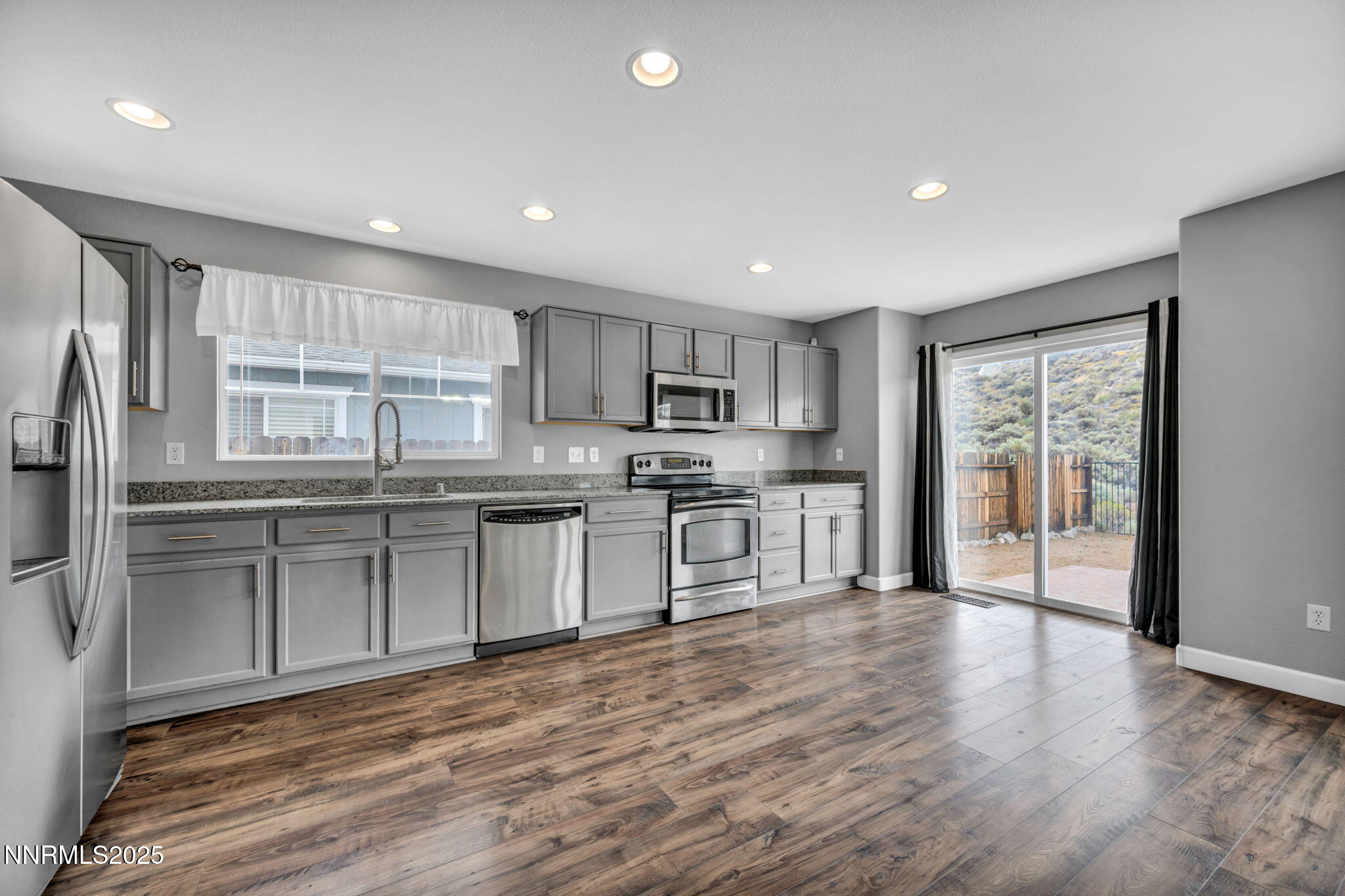 7644 Corso Street Reno, NV 89506 - Photo 35 of 54 a kitchen with stainless steel appliances granite countertop a refrigerator sink and cabinets