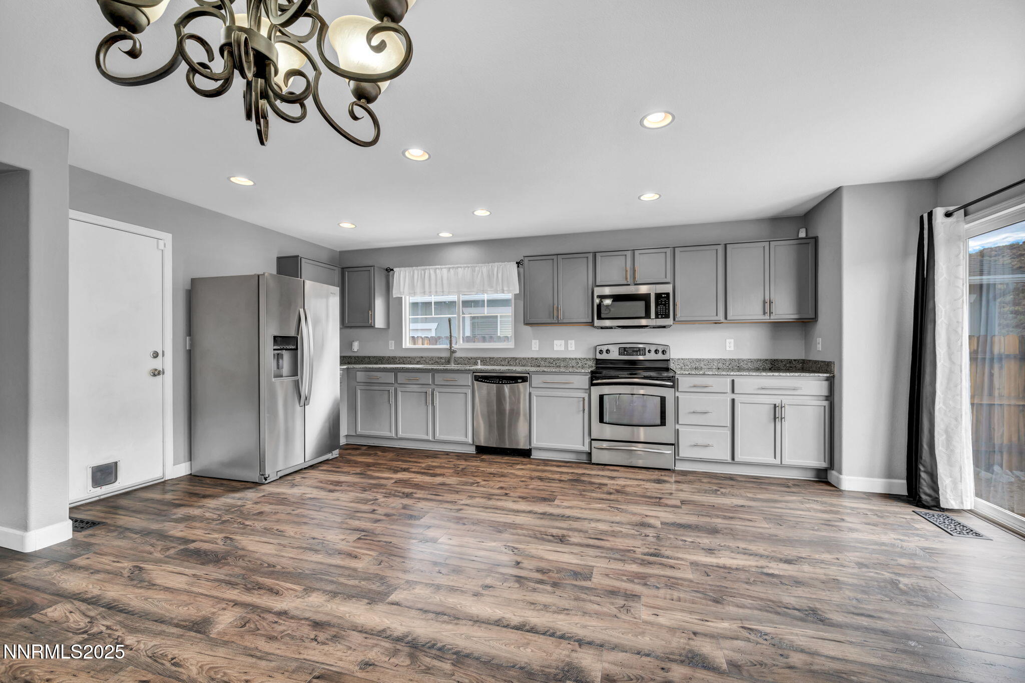7644 Corso Street Reno, NV 89506 - Photo 36 of 54 a kitchen with stainless steel appliances granite countertop a refrigerator and a stove top oven