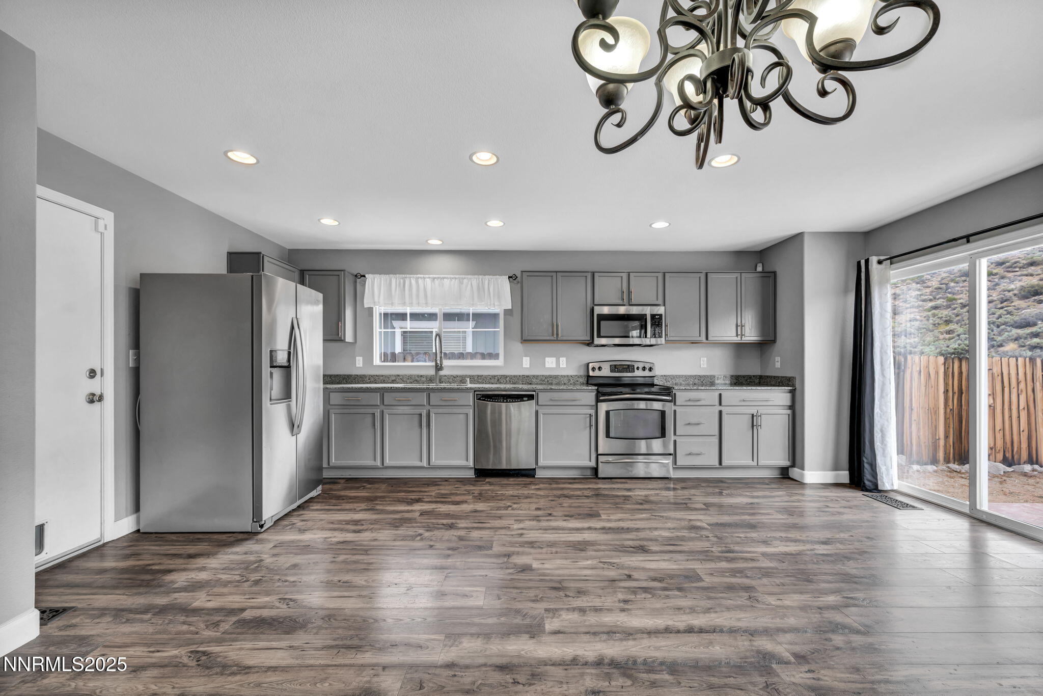 7644 Corso Street Reno, NV 89506 - Photo 37 of 54 a kitchen with stainless steel appliances granite countertop a refrigerator and a stove top oven