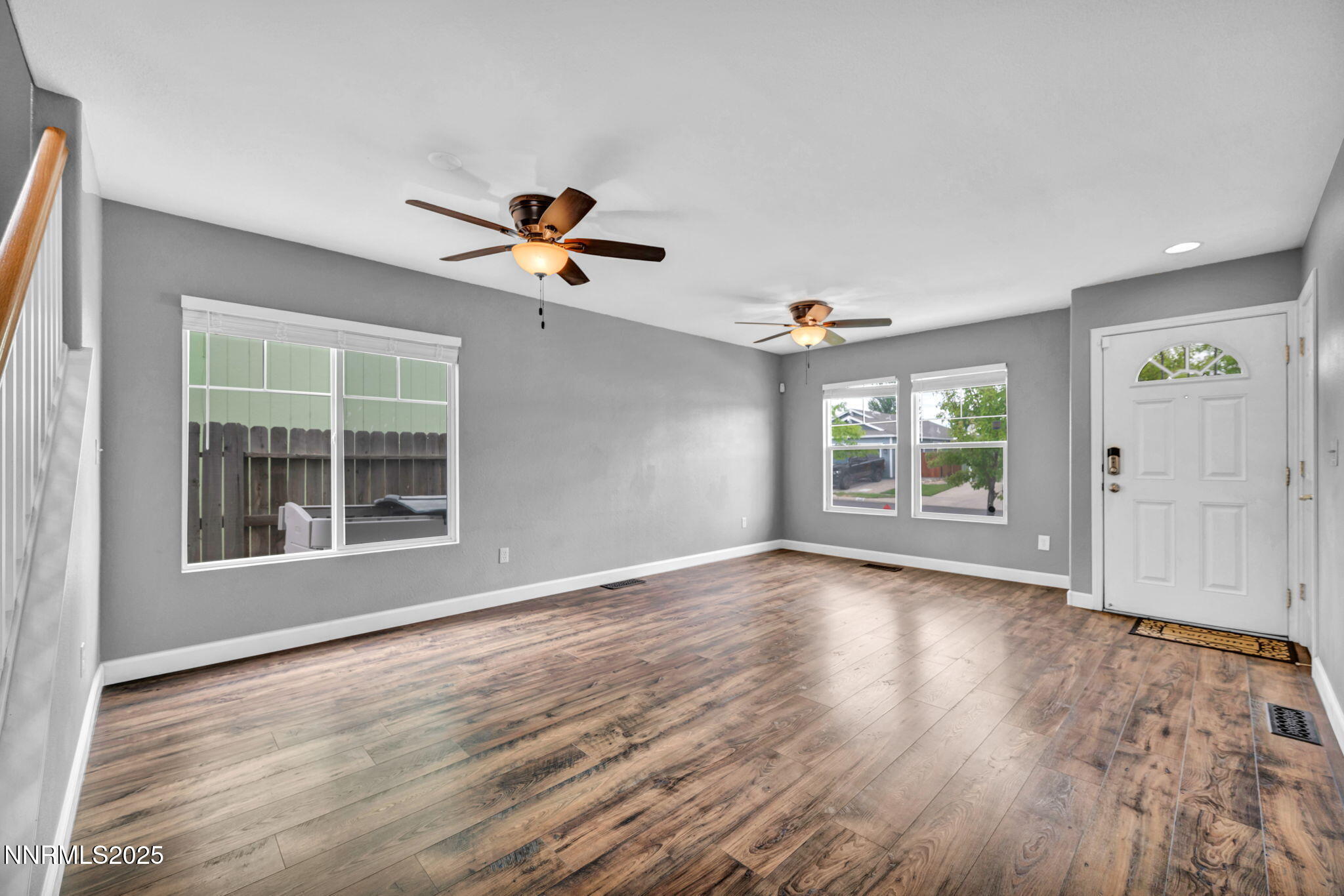 7644 Corso Street Reno, NV 89506 - Photo 49 of 54 a view of an empty room with a window and wooden floor