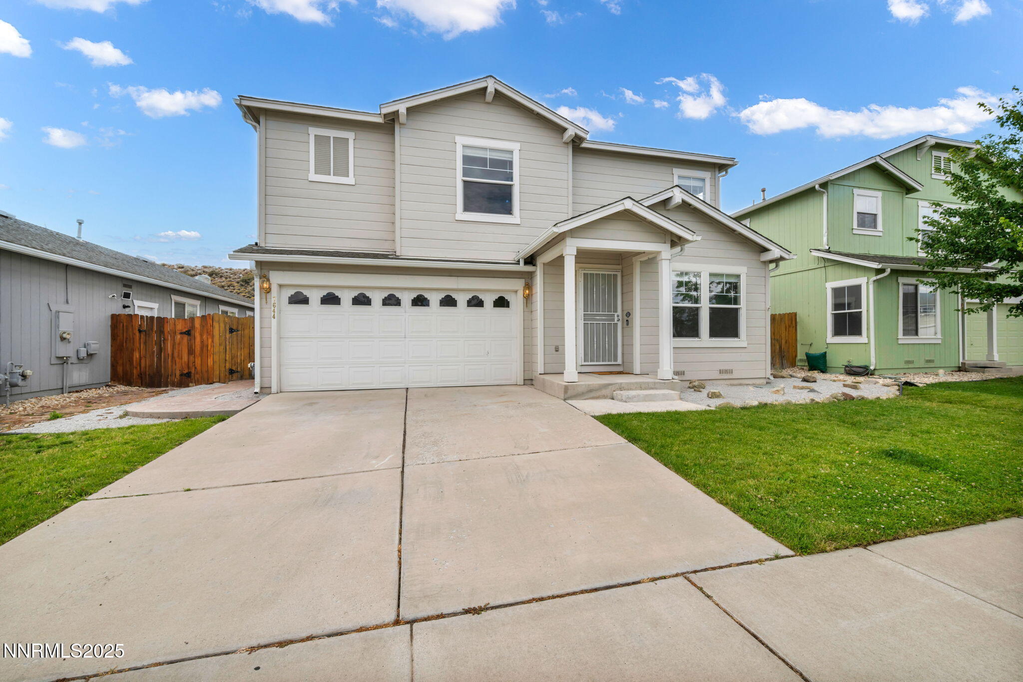 7644 Corso Street Reno, NV 89506 - Photo 5 of 54 a front view of a house with a yard and a garage