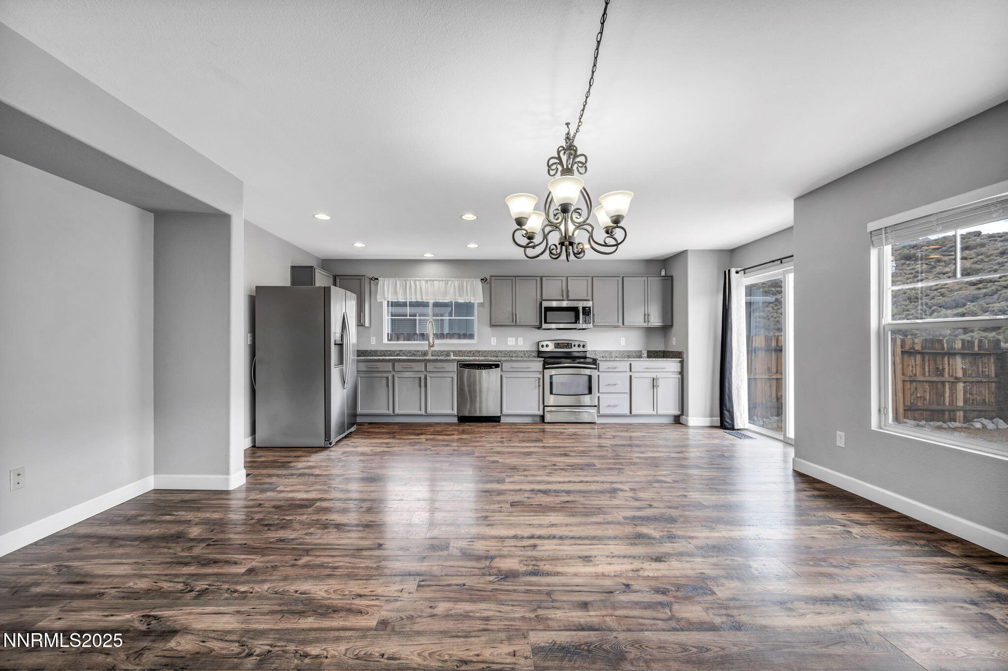 7644 Corso Street Reno, NV 89506 - Photo 52 of 54 a large room with wooden floor chandelier and windows