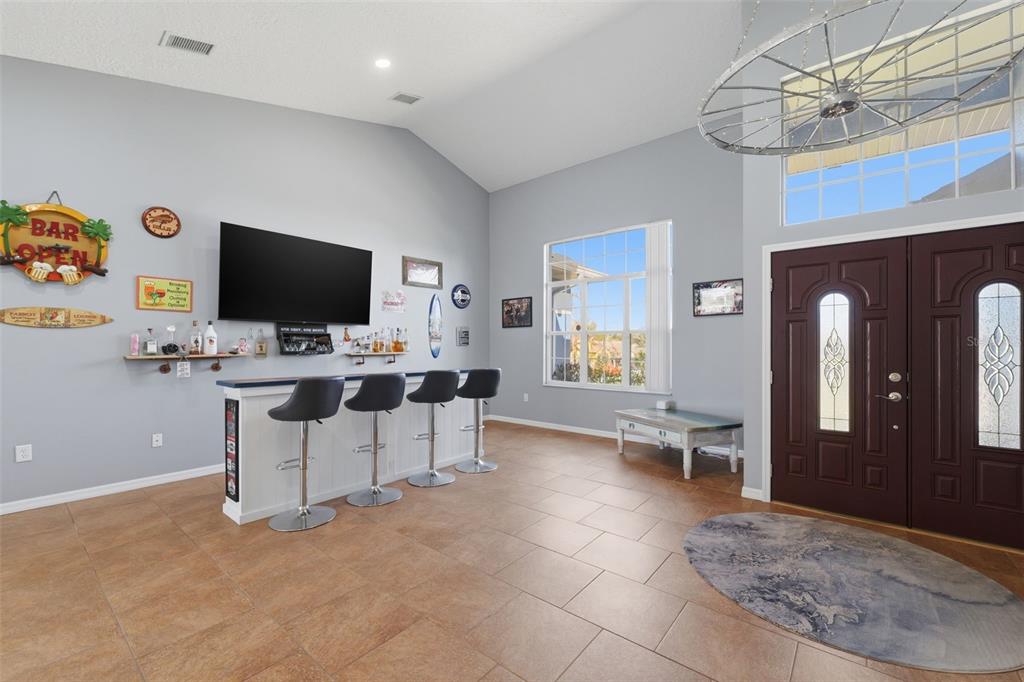 7442 Aloe Drive Spring Hill, FL 34607 - Photo 12 of 59 a work room with furniture and a flat screen tv