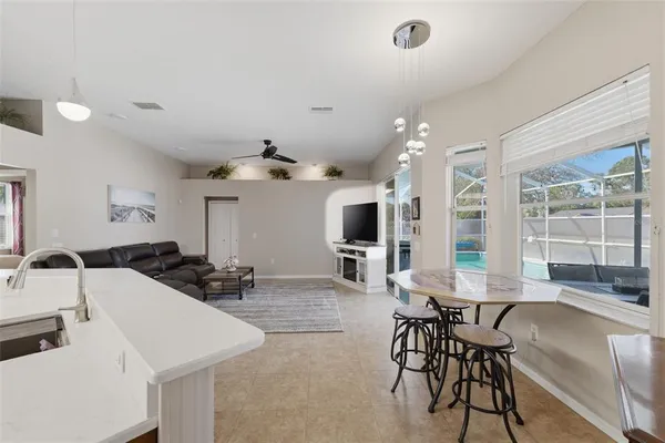 a kitchen with stainless steel appliances granite countertop a sink a stove top oven a counter space and cabinets