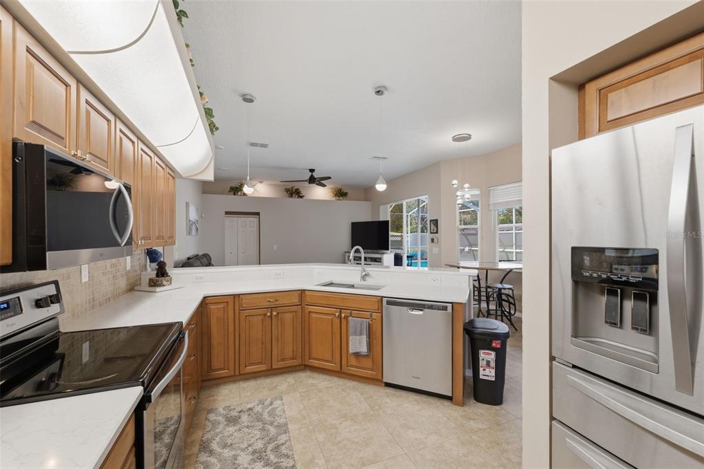 7442 Aloe Drive Spring Hill, FL 34607 - Photo 19 of 59 a kitchen with a sink stainless steel appliances and cabinets