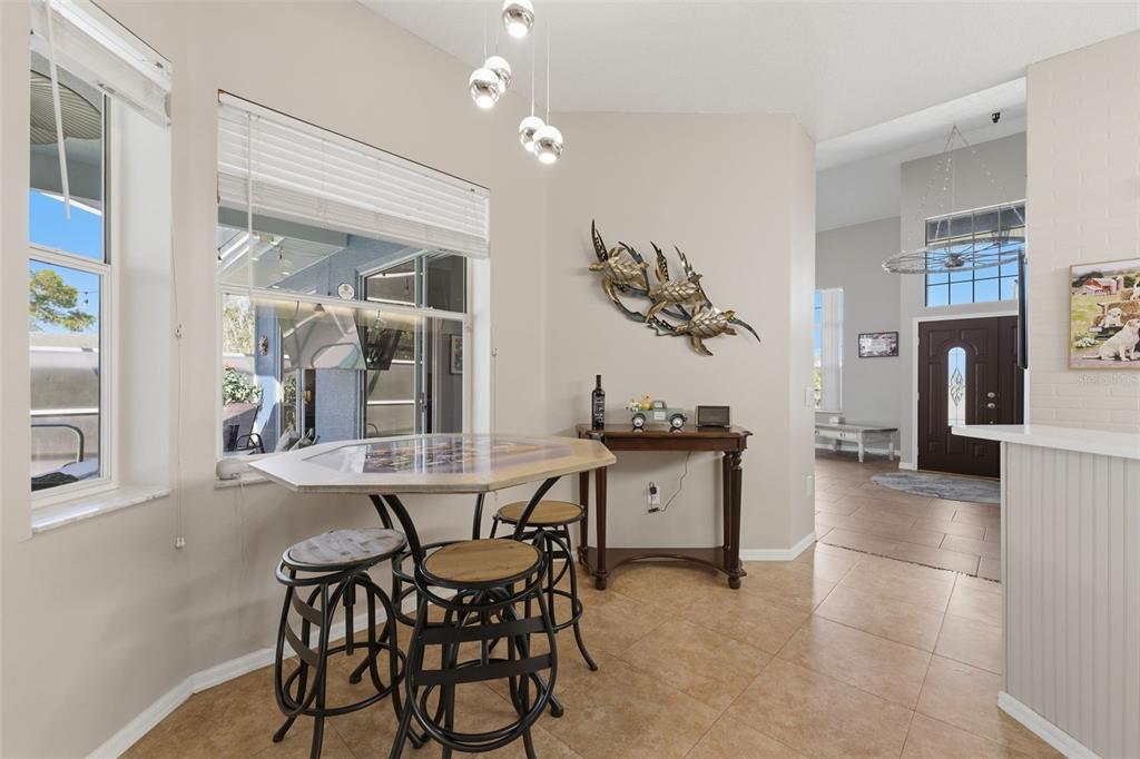 7442 Aloe Drive Spring Hill, FL 34607 - Photo 20 of 59 a view of a dining room with furniture and chandelier