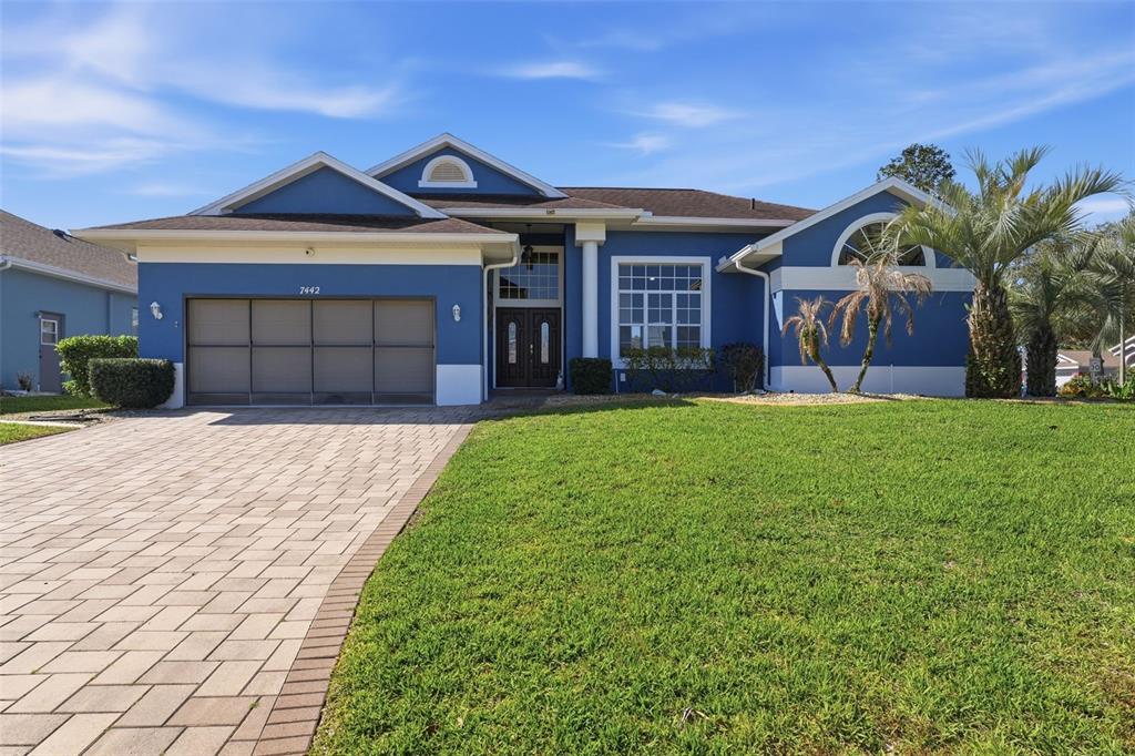 7442 Aloe Drive Spring Hill, FL 34607 - Photo 2 of 59 a front view of a house with garden