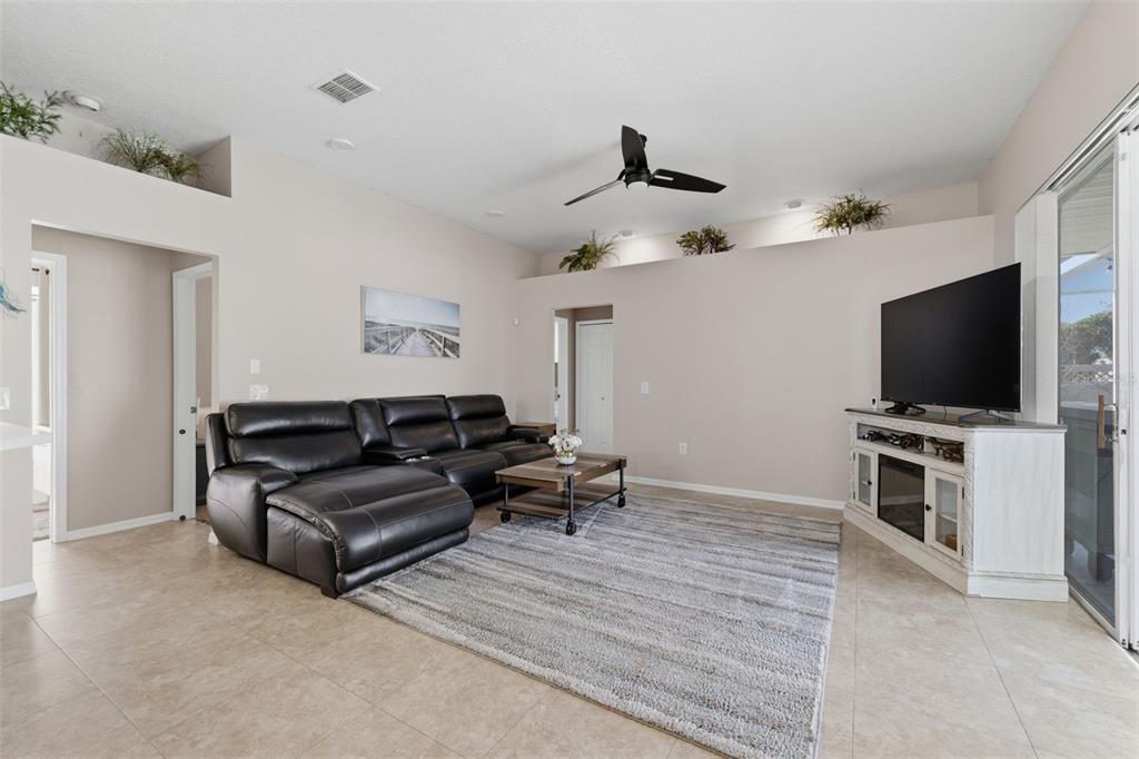 7442 Aloe Drive Spring Hill, FL 34607 - Photo 22 of 59 a living room with furniture and a flat screen tv