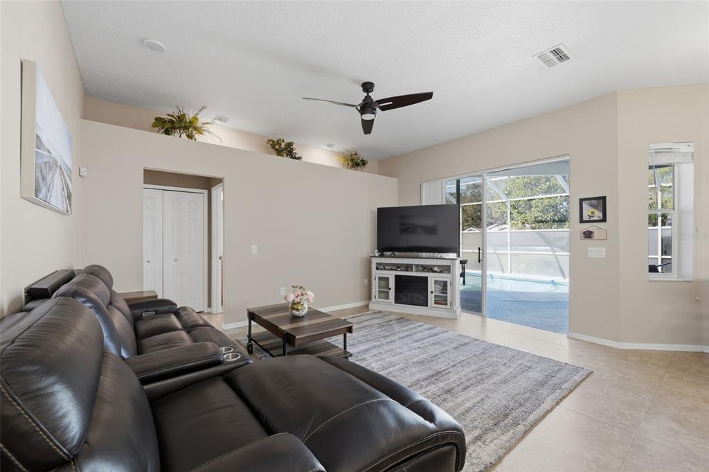 7442 Aloe Drive Spring Hill, FL 34607 - Photo 23 of 59 a living room with furniture and a flat screen tv