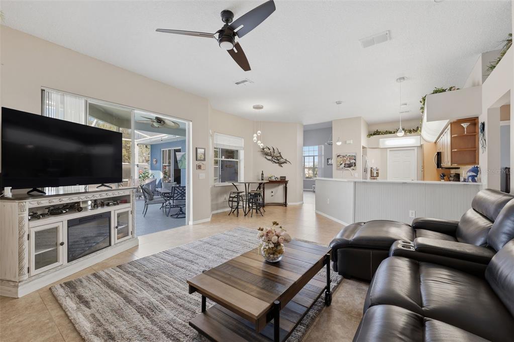 7442 Aloe Drive Spring Hill, FL 34607 - Photo 24 of 59 a living room with furniture and a flat screen tv