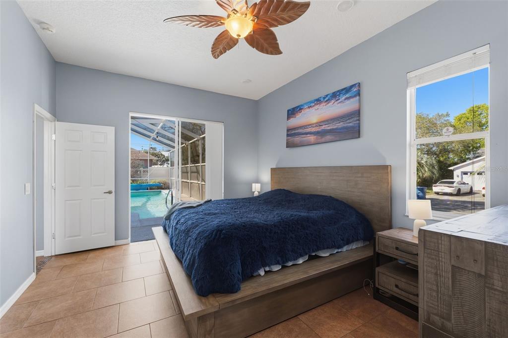 7442 Aloe Drive Spring Hill, FL 34607 - Photo 26 of 59 a bedroom with a bed and a chandelier