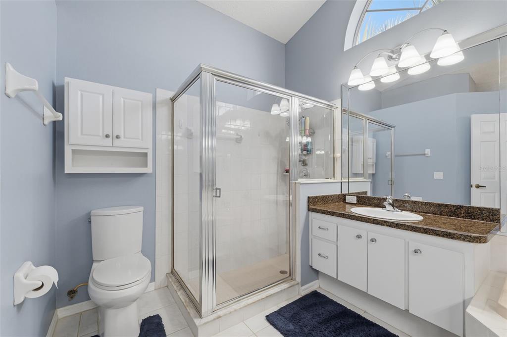 7442 Aloe Drive Spring Hill, FL 34607 - Photo 28 of 59 a bathroom with a granite countertop sink toilet and shower