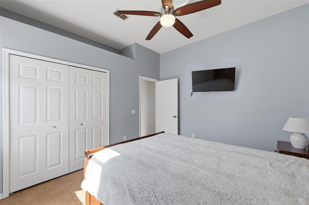 7442 Aloe Drive Spring Hill, FL 34607 - Photo 32 of 59 a bedroom with a bed and a flat screen tv