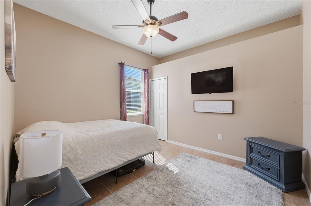 7442 Aloe Drive Spring Hill, FL 34607 - Photo 33 of 59 a bedroom with a bed and a flat screen tv
