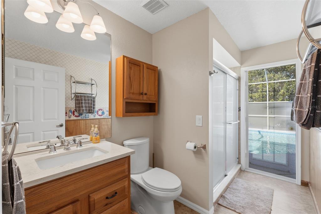 7442 Aloe Drive Spring Hill, FL 34607 - Photo 35 of 59 a bathroom with a sink a toilet a mirror and shower