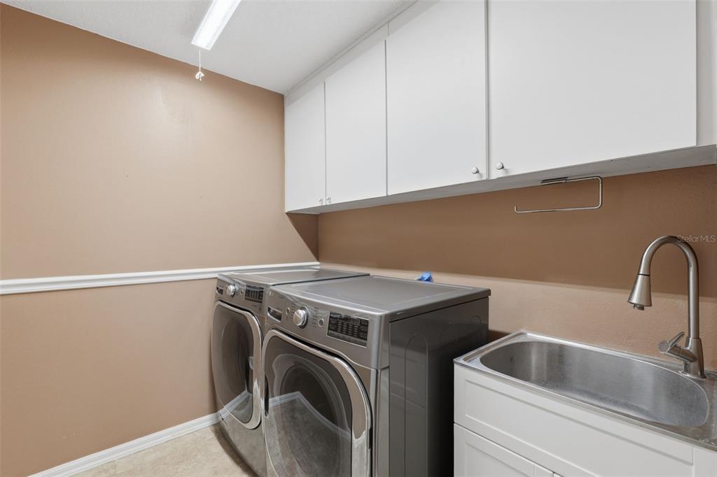 7442 Aloe Drive Spring Hill, FL 34607 - Photo 37 of 59 a utility room with dryer and washer
