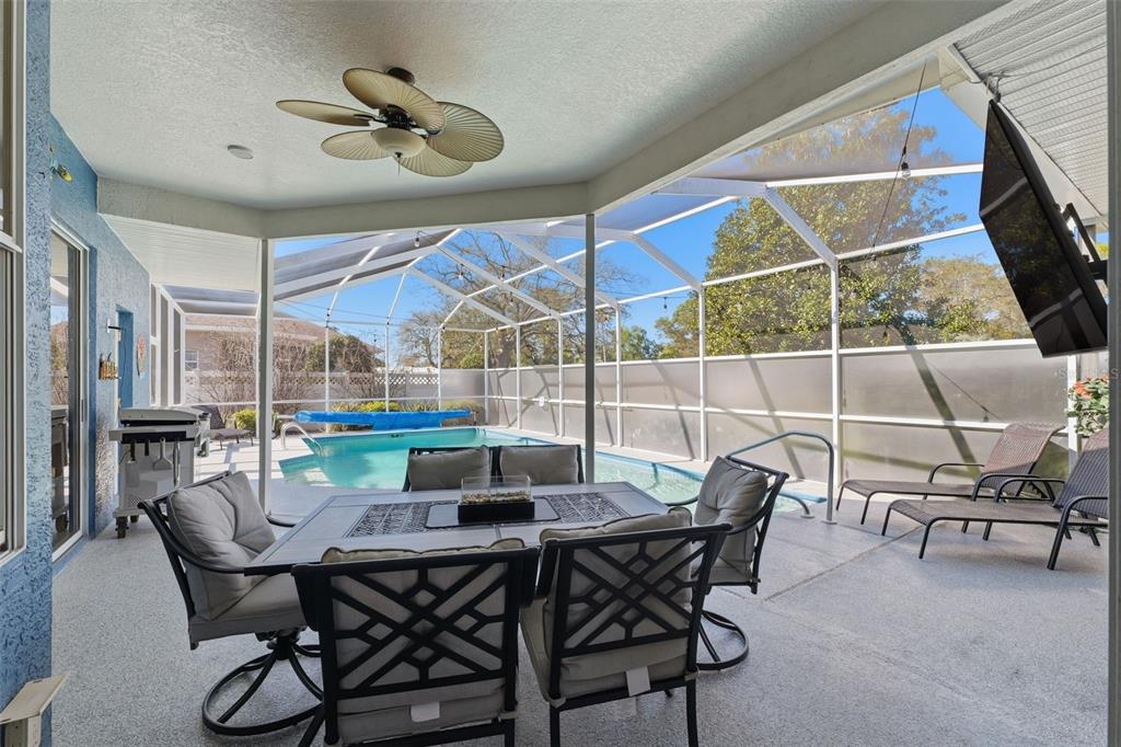 7442 Aloe Drive Spring Hill, FL 34607 - Photo 40 of 59 a view of a dining room with furniture and chandelier