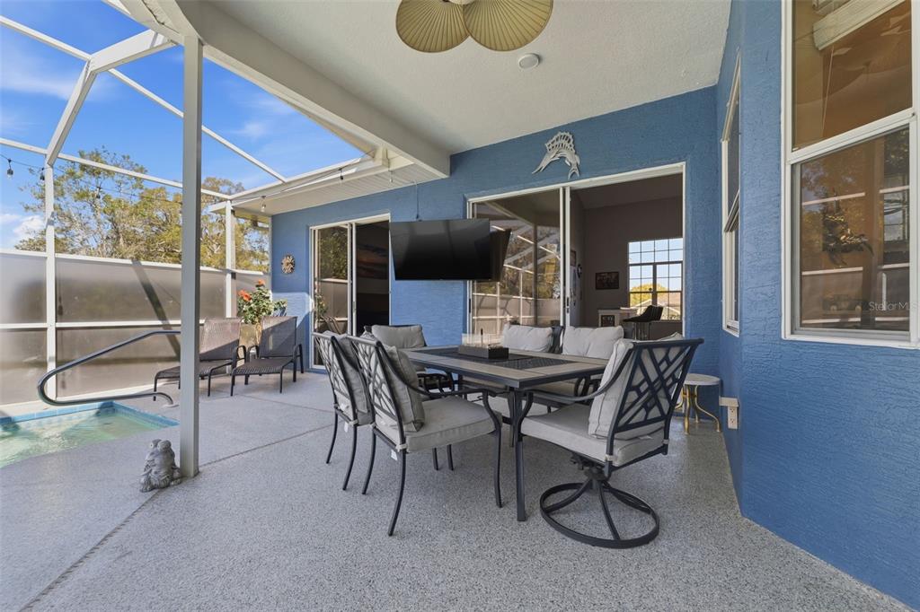 7442 Aloe Drive Spring Hill, FL 34607 - Photo 43 of 59 a view of a dining room with furniture and chandelier