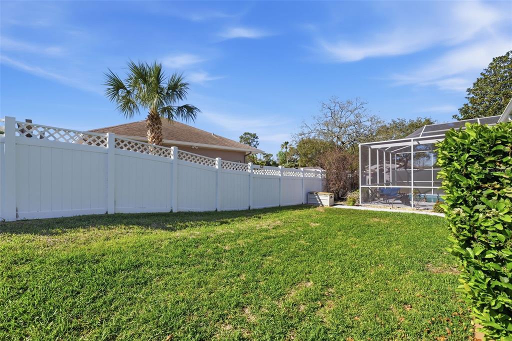 7442 Aloe Drive Spring Hill, FL 34607 - Photo 46 of 59 a view of a house with a garden and yard