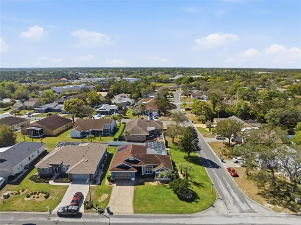 an aerial view of residential houses with outdoor space and street view
