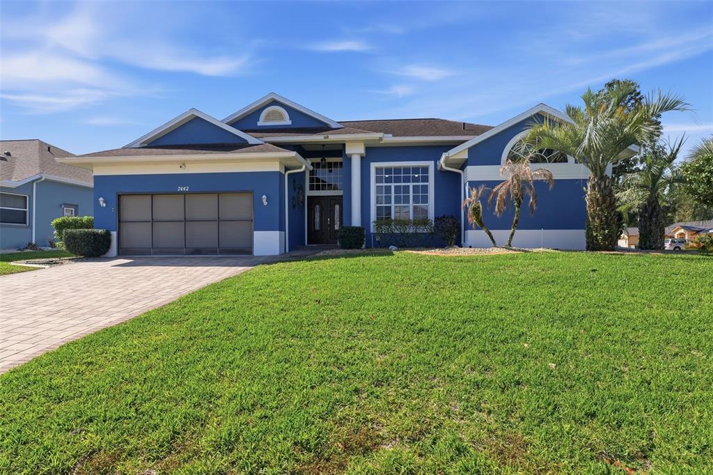 7442 Aloe Drive Spring Hill, FL 34607 - Photo 6 of 59 a front view of a house with a yard and garage