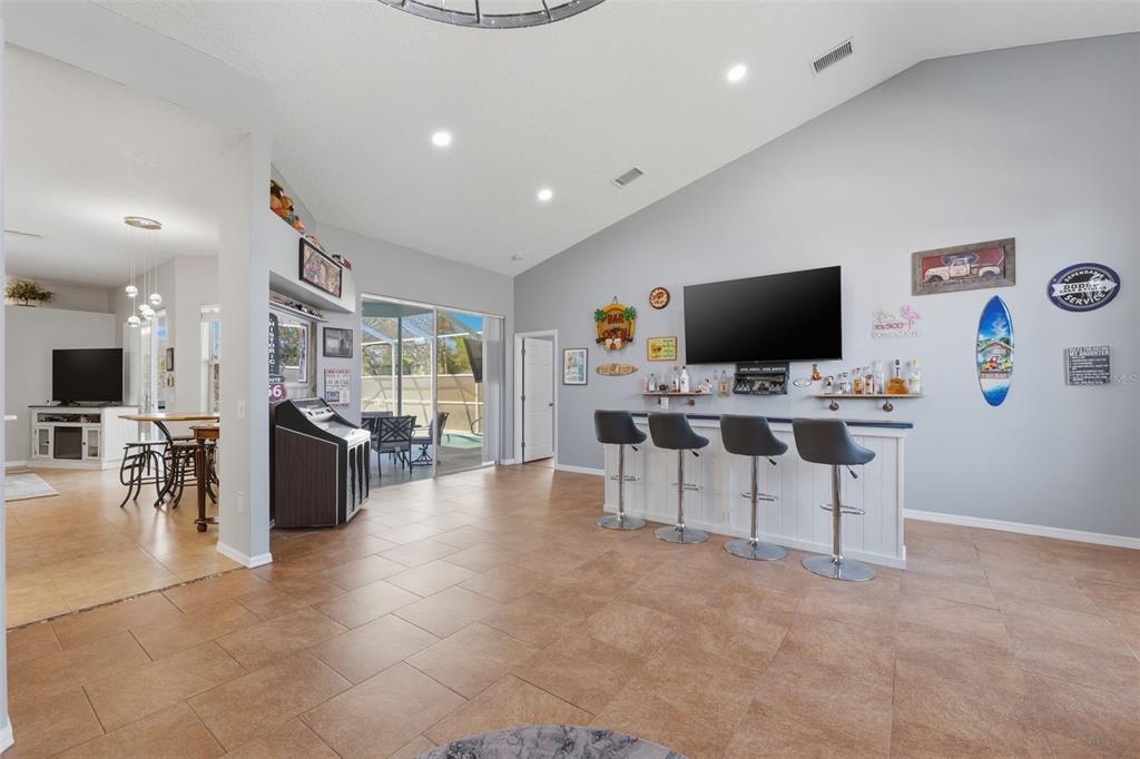 7442 Aloe Drive Spring Hill, FL 34607 - Photo 8 of 59 a view of a livingroom with furniture and a flat screen tv
