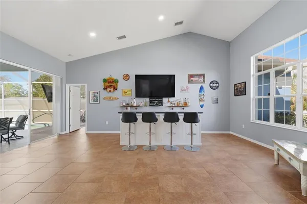 a view of a workspace with furniture and a flat screen tv