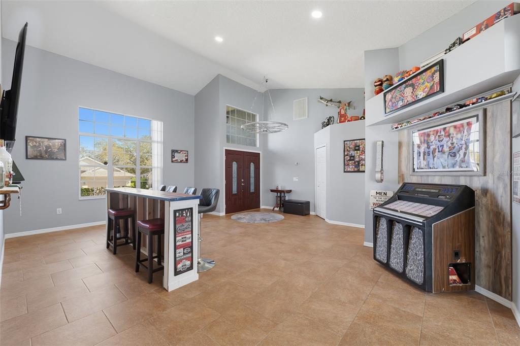 7442 Aloe Drive Spring Hill, FL 34607 - Photo 10 of 59 a view of a workspace with furniture and a flat screen tv
