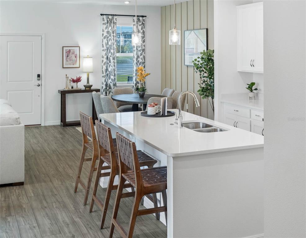 1808 Shadow Box Bend St. Cloud, FL 34771 - Photo 13 of 40 a view of a dining room with furniture and wooden floor