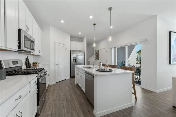 a kitchen with stainless steel appliances granite countertop a stove oven and a refrigerator