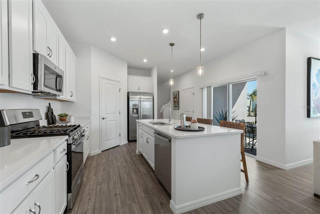 1808 Shadow Box Bend St. Cloud, FL 34771 - Photo 14 of 40 a kitchen with stainless steel appliances granite countertop a stove oven and a refrigerator