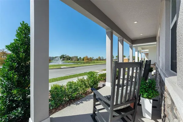a view of a balcony with chair and wooden floor