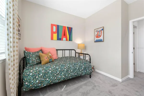 a bedroom with a bed and a painting on the wall