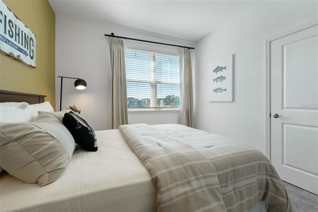 1808 Shadow Box Bend St. Cloud, FL 34771 - Photo 27 of 40 a bedroom with a bed and a window