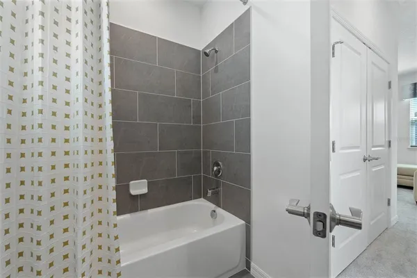 a bathroom with a bathtub and a shower