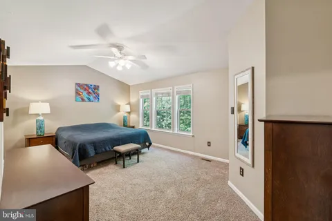 a bed room with a bed and a chandelier