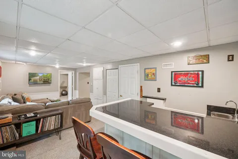 a kitchen with stainless steel appliances granite countertop a sink and a refrigerator